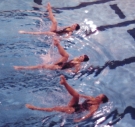 three Swarthmore synchronized swimmers performing in the pool
